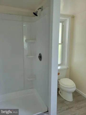 a bathroom with a toilet and shower