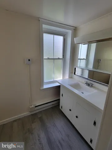a bathroom with a double vanity sink and mirror