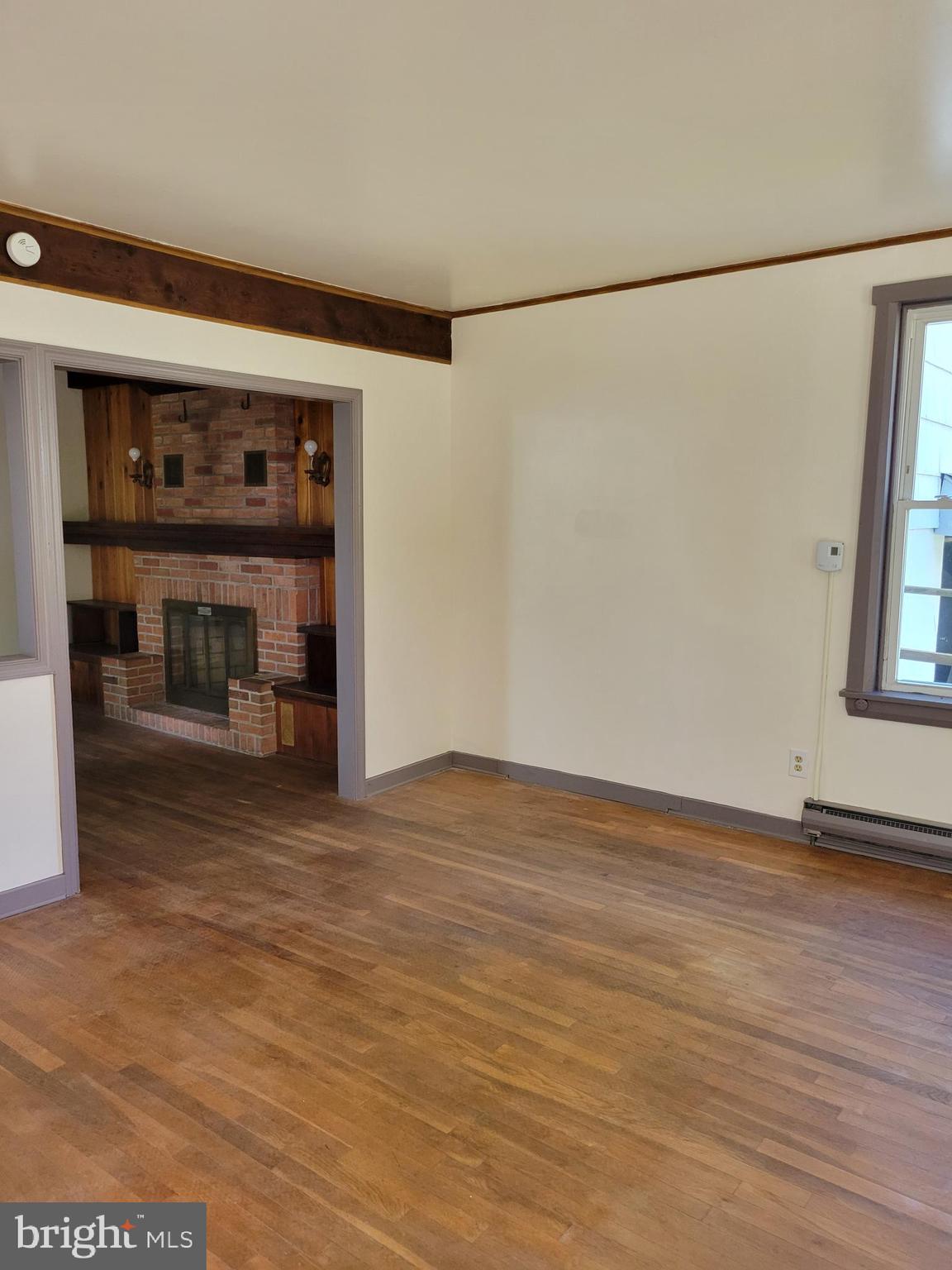 40 Star Road Hereford, PA 18056 - Photo 9 of 20 a view of empty room with wooden floor and fan