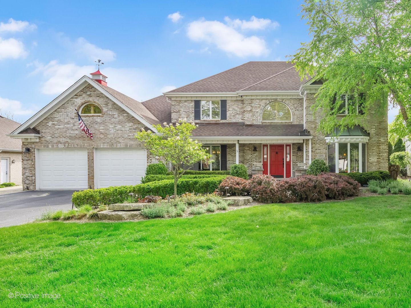 6451 Garfield Ridge Court Burr Ridge, IL 60527 - Photo 1 of 28 a front view of a house with a garden and plants