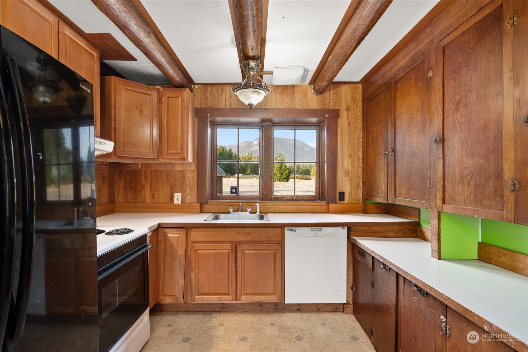 111 Huntington Road Packwood, WA 98361 - Photo 19 of 40 a kitchen with a sink stove and cabinets