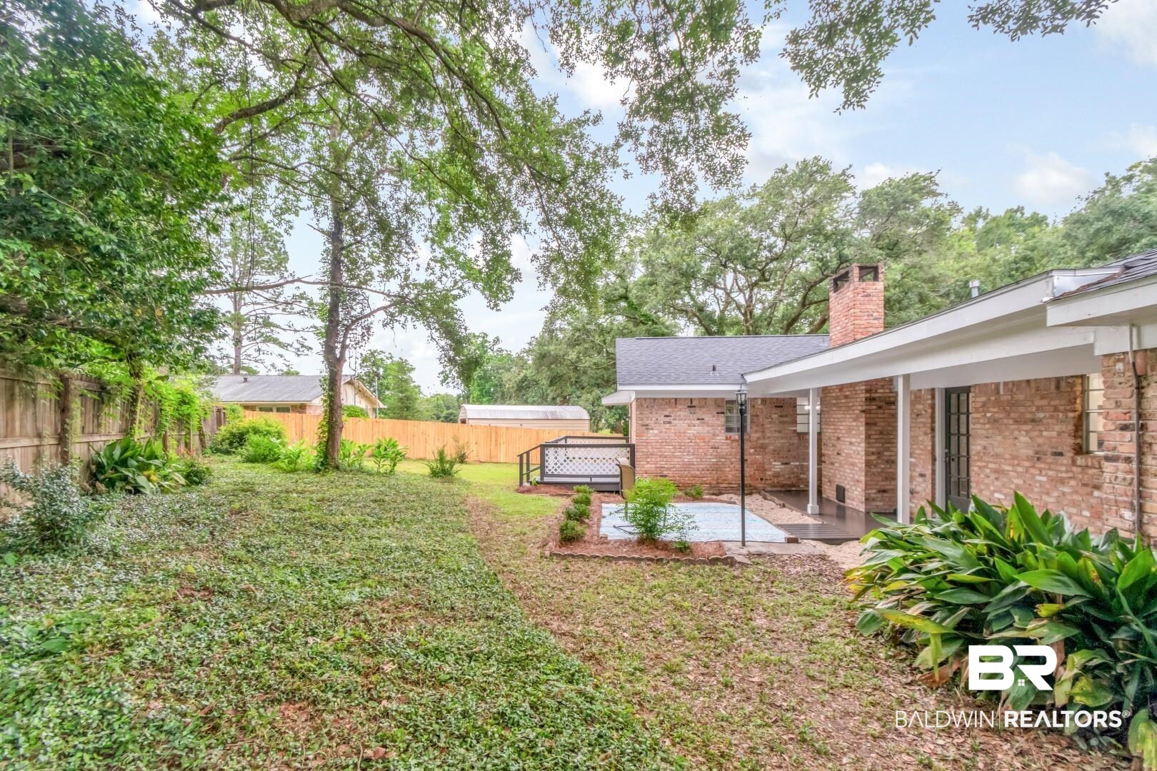 5217 Perin Road Mobile, AL 36693 - Photo 37 of 45 Expansive rear yard featuring mature trees and a privacy fence