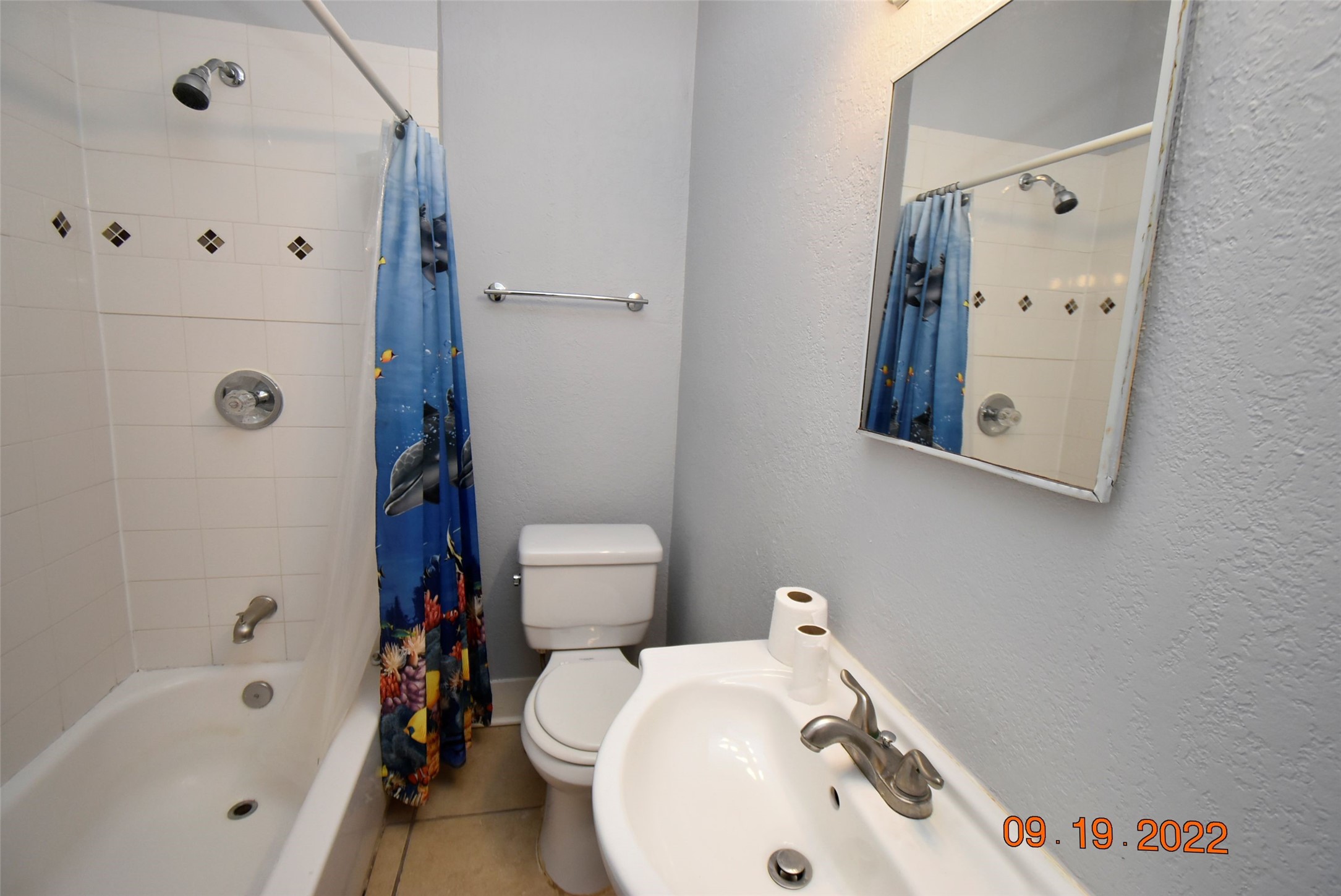 5405 Avenue R Galveston, TX 77551 - Photo 12 of 30 a bathroom with a sink a toilet and shower