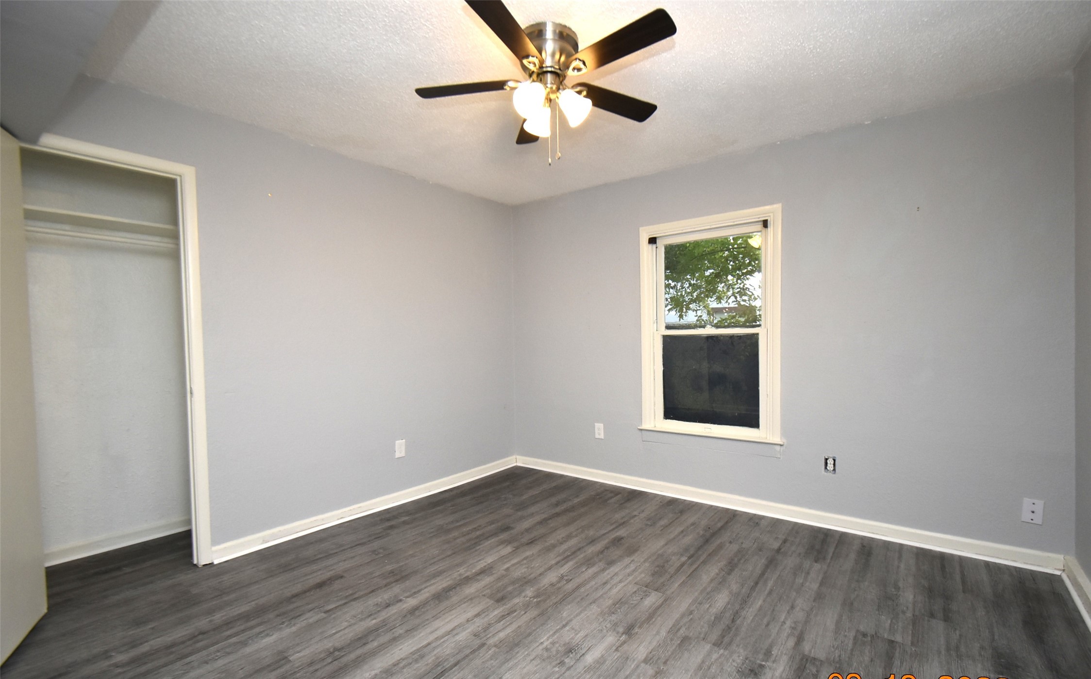 5405 Avenue R Galveston, TX 77551 - Photo 13 of 30 an empty room with wooden floor chandelier fan and windows