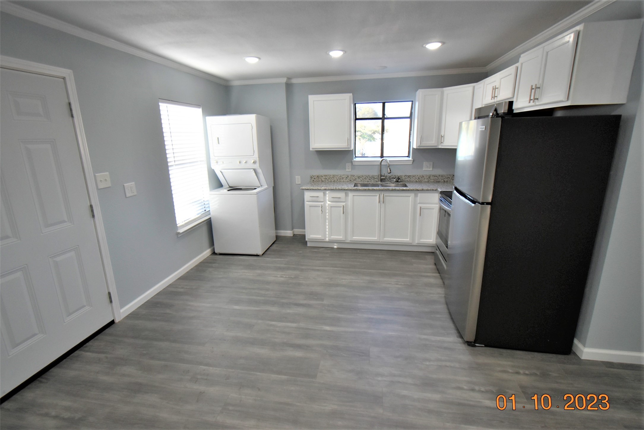 5405 Avenue R Galveston, TX 77551 - Photo 23 of 30 a kitchen with a refrigerator and a sink