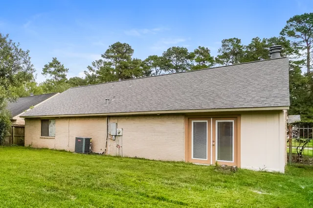 a house with green field in front of it