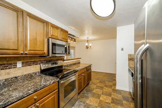 a kitchen with a sink stove and refrigerator