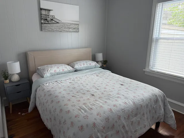 a large bed sitting in a bedroom next to a window