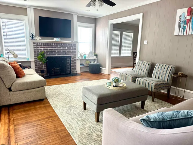 a living room with furniture fireplace and flat screen tv