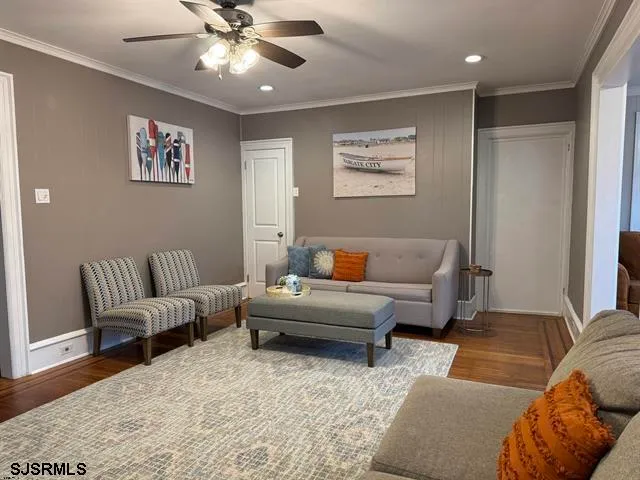 a living room with furniture and a ceiling fan