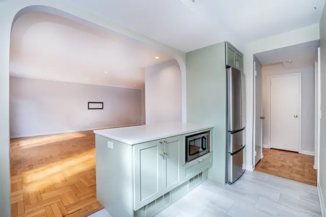 a view of kitchen with stainless steel appliances granite countertop cabinets and wooden floor