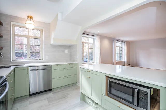 a kitchen with a sink stove and cabinets