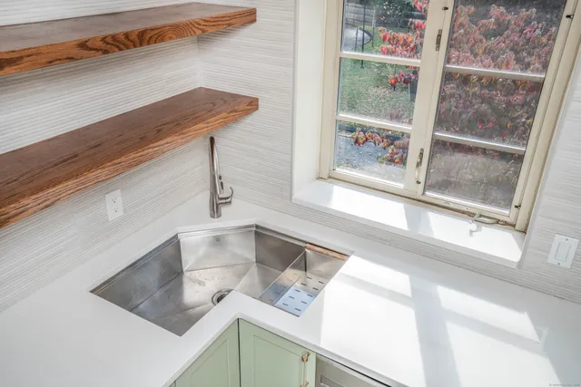 a kitchen with a window a sink and a counter top space