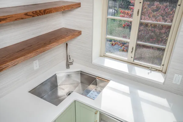 a kitchen with a window a sink and a counter top space