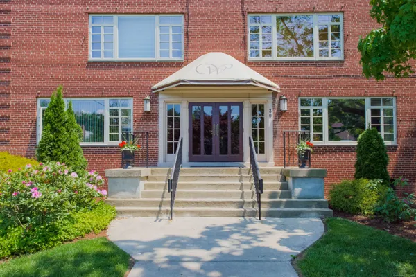 front view of brick house with a small yard