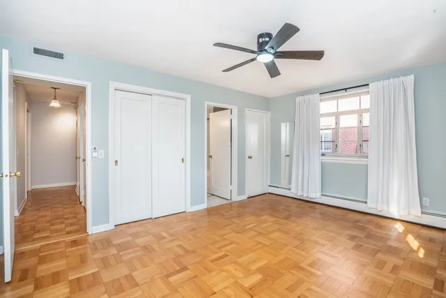 a view of a livingroom with a ceiling fan and window