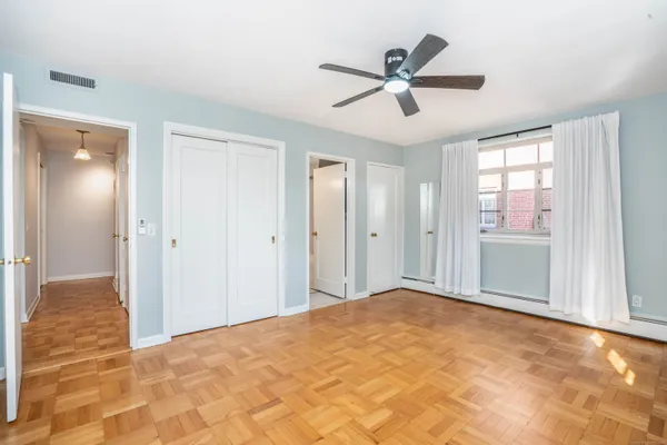 a view of a livingroom with a ceiling fan and window