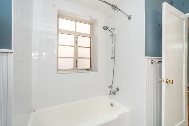 a white bath tub sitting next to a window