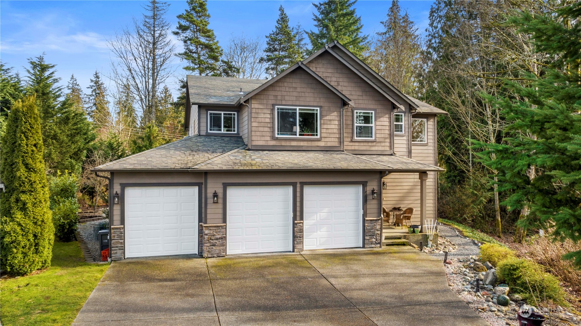 a front view of a house with a garden