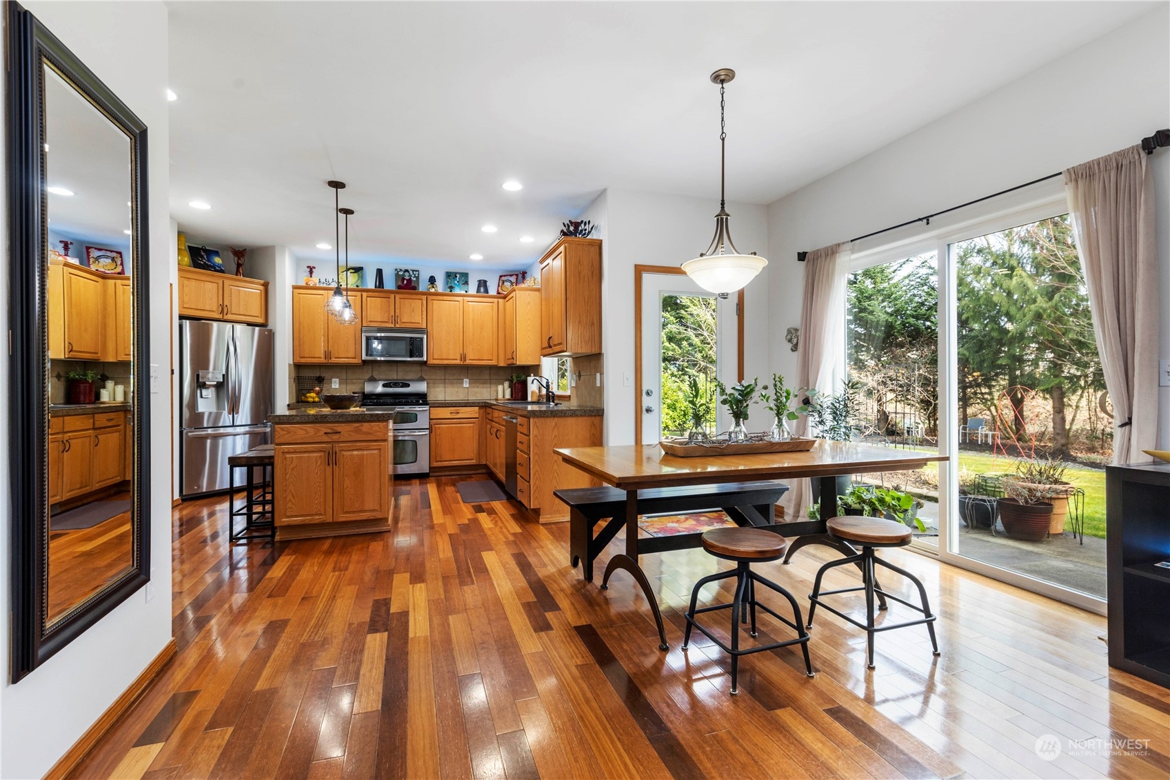 4712 152nd Place Southeast Bothell, WA 98012 - Photo 13 of 31 a kitchen with stainless steel appliances granite countertop table chairs and a view of living room