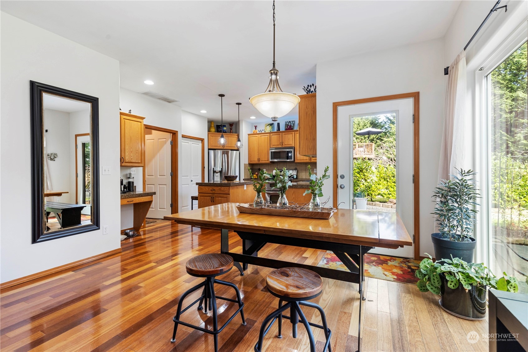 4712 152nd Place Southeast Bothell, WA 98012 - Photo 14 of 31 a view of a dining room with furniture window and wooden floor