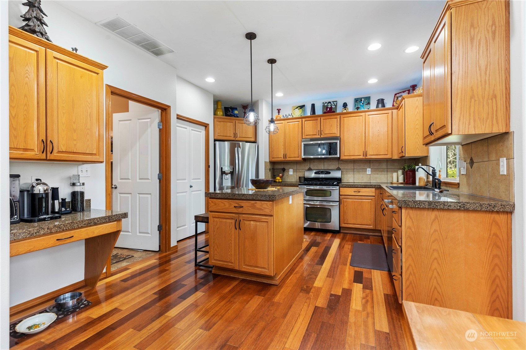 4712 152nd Place Southeast Bothell, WA 98012 - Photo 15 of 31 a kitchen with stainless steel appliances a refrigerator sink and cabinets