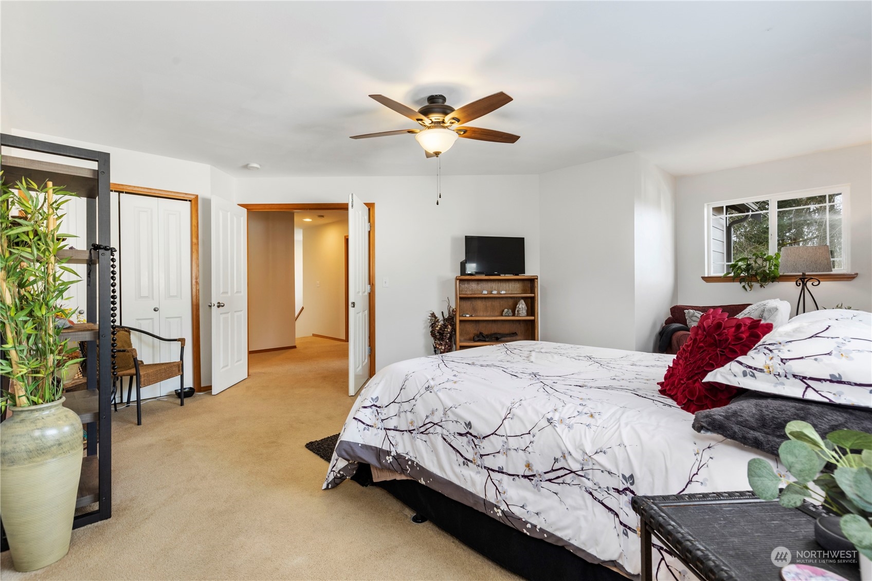 4712 152nd Place Southeast Bothell, WA 98012 - Photo 19 of 31 a bedroom with a bed and a chandelier