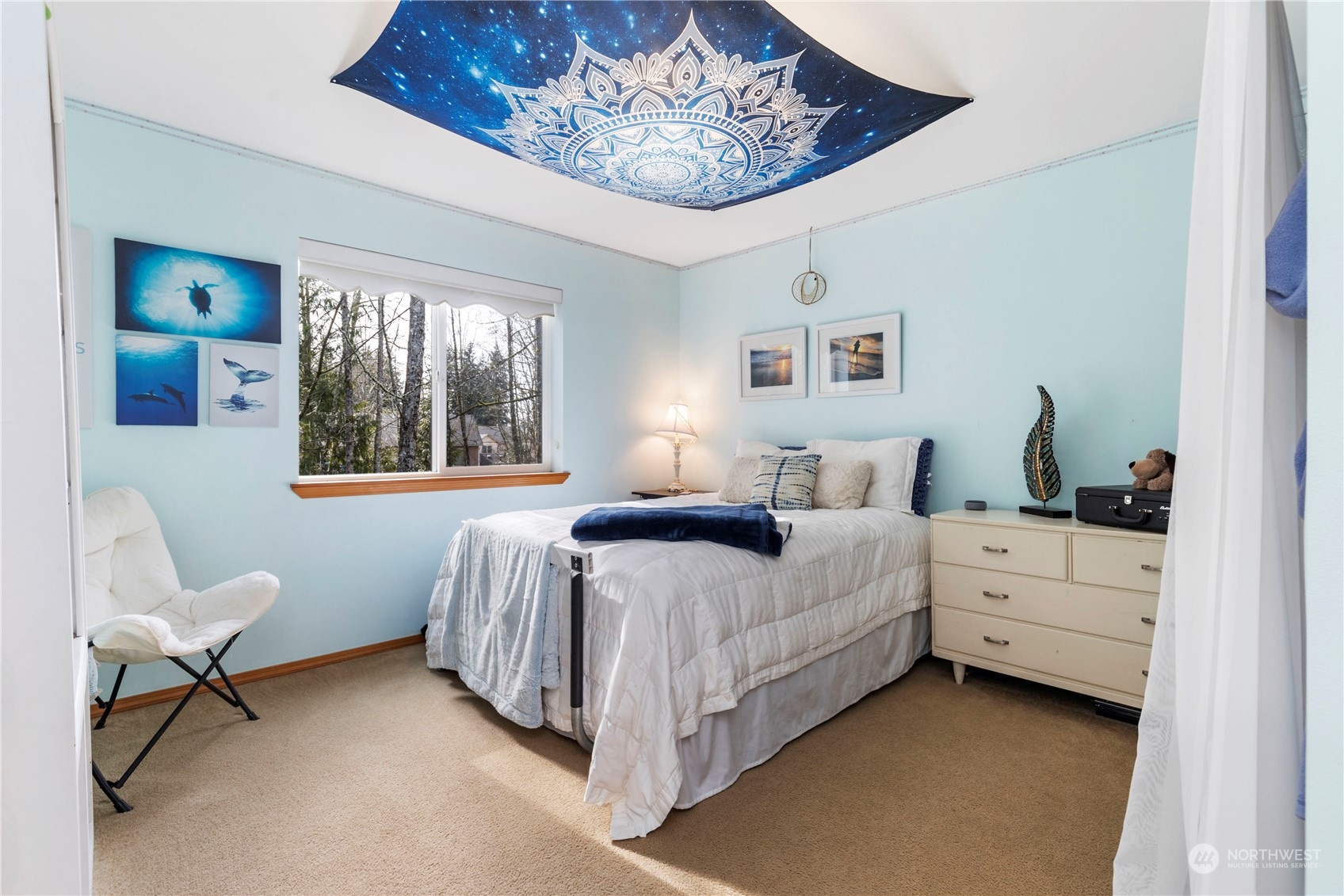 4712 152nd Place Southeast Bothell, WA 98012 - Photo 25 of 31 a bedroom with a bed and a chandelier