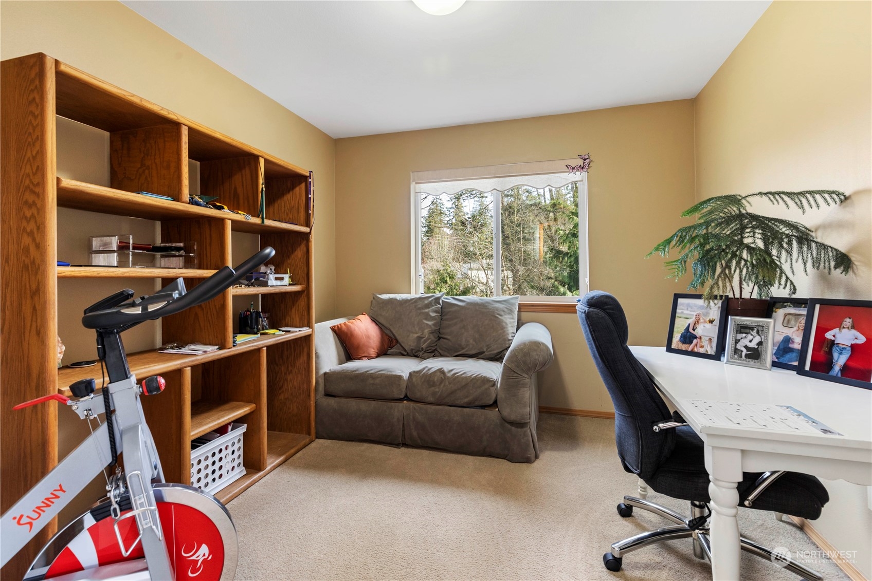 4712 152nd Place Southeast Bothell, WA 98012 - Photo 26 of 31 a living room with furniture and a bookshelf