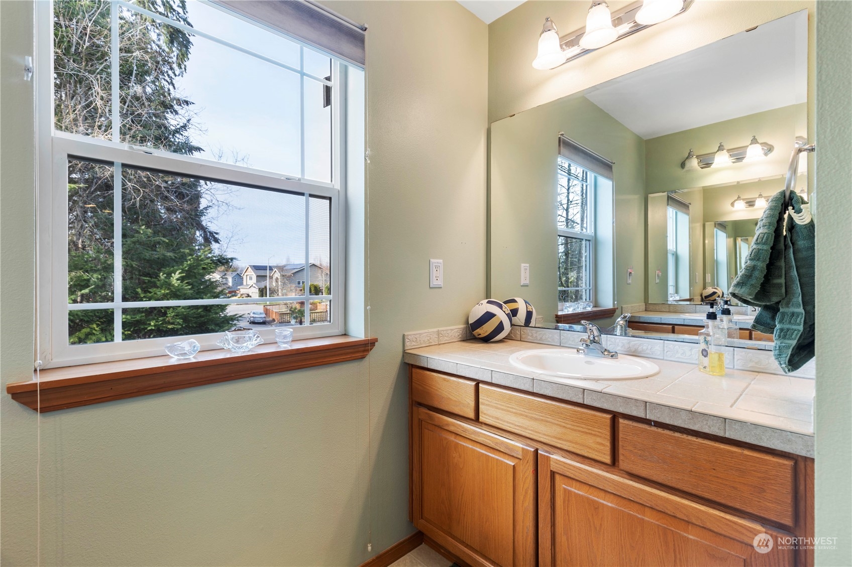 4712 152nd Place Southeast Bothell, WA 98012 - Photo 27 of 31 a bathroom with a sink mirror and window