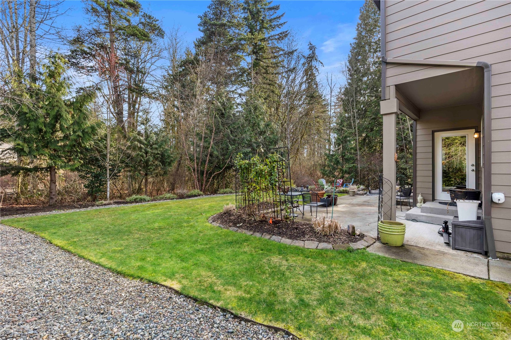 4712 152nd Place Southeast Bothell, WA 98012 - Photo 28 of 31 a view of a backyard with table and chairs potted plants and large tree