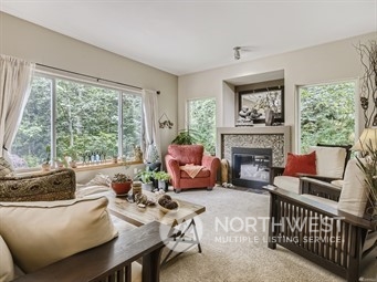 4712 152nd Place Southeast Bothell, WA 98012 - Photo 7 of 31 a living room with furniture a fireplace and a large window
