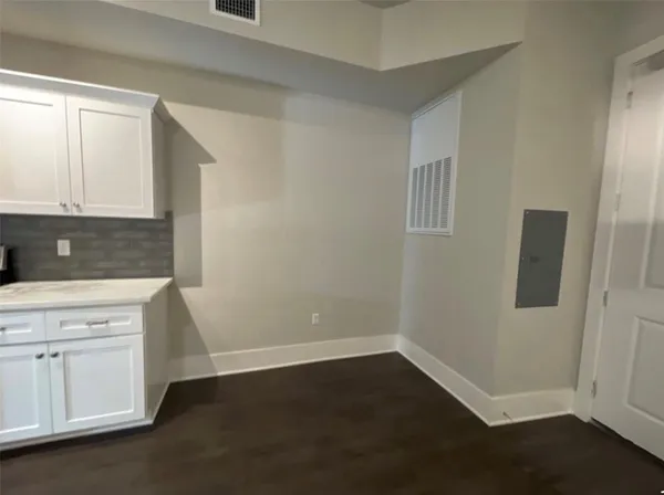 an empty room with a fan & a ceiling fan