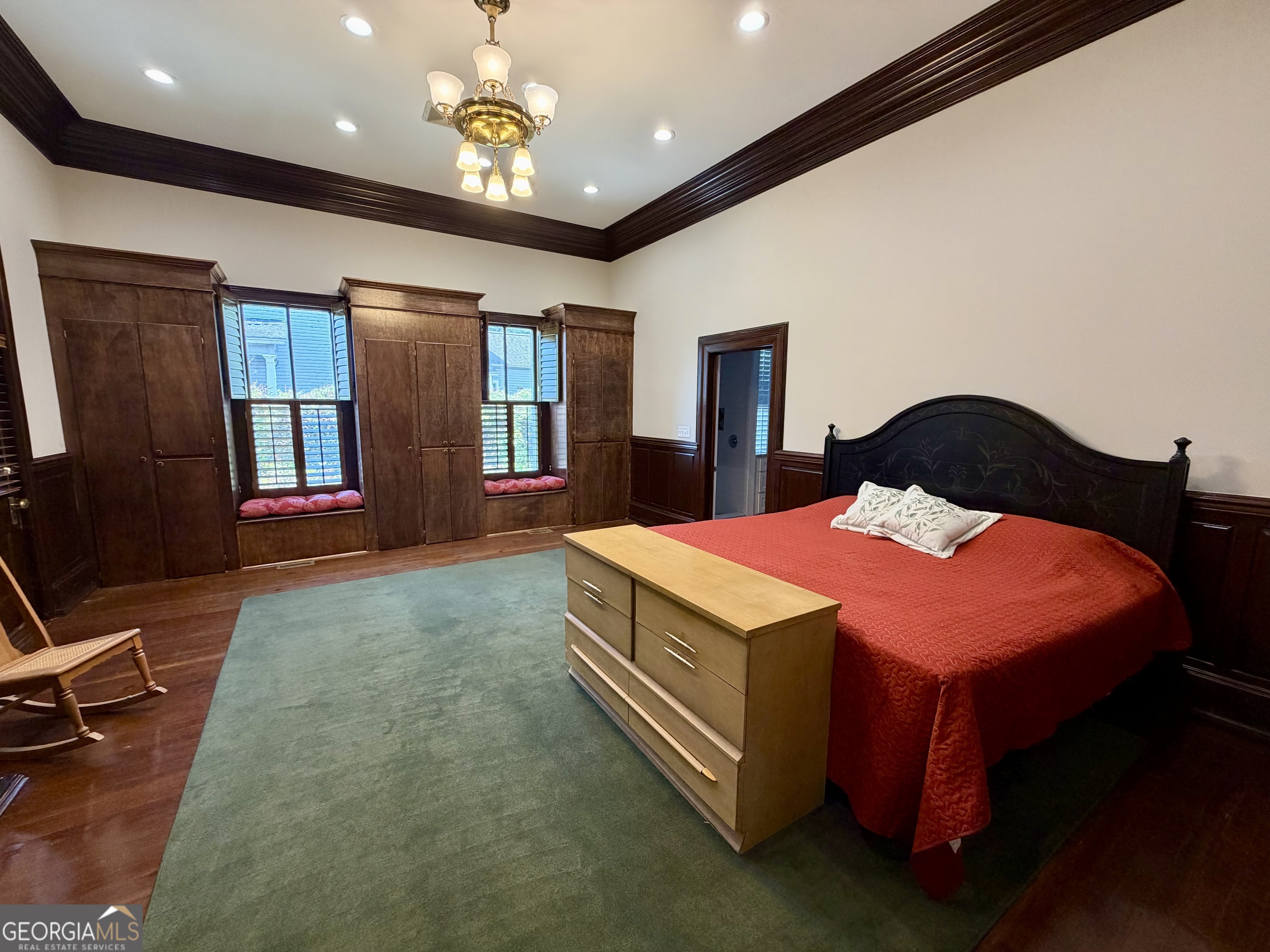610 North Ridge Avenue Tifton, GA 31794 - Photo 15 of 32 a bedroom with a bed and a chandelier