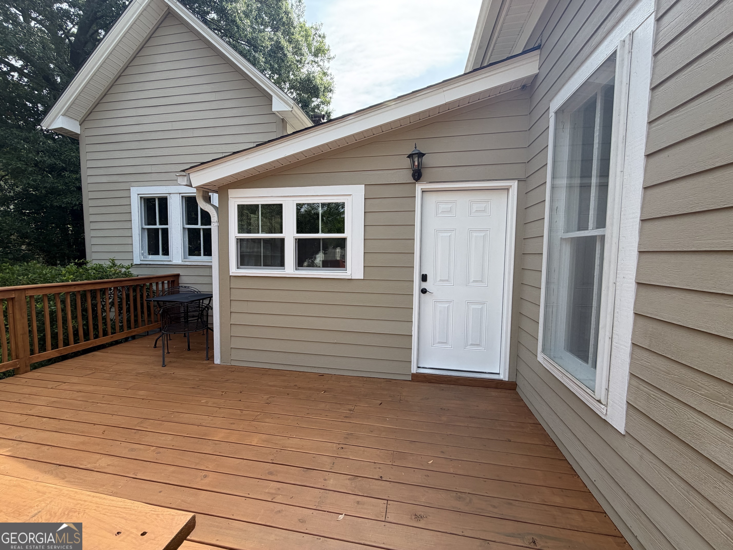 610 North Ridge Avenue Tifton, GA 31794 - Photo 31 of 32 a view of deck house with wooden deck and floor to ceiling window