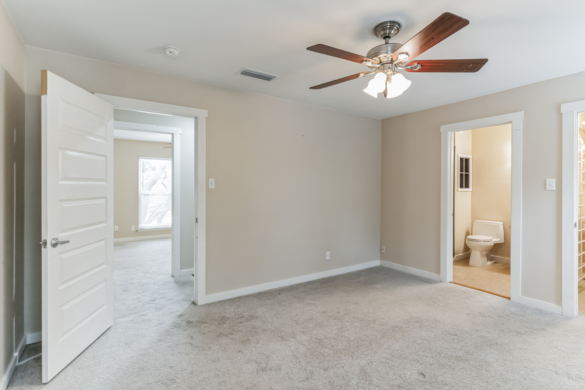 3214 Clawson Road, Unit A Austin, TX 78704 - Photo 17 of 26 A quiet bedroom with light carpeted floors, featuring a ceiling fan for comfort.