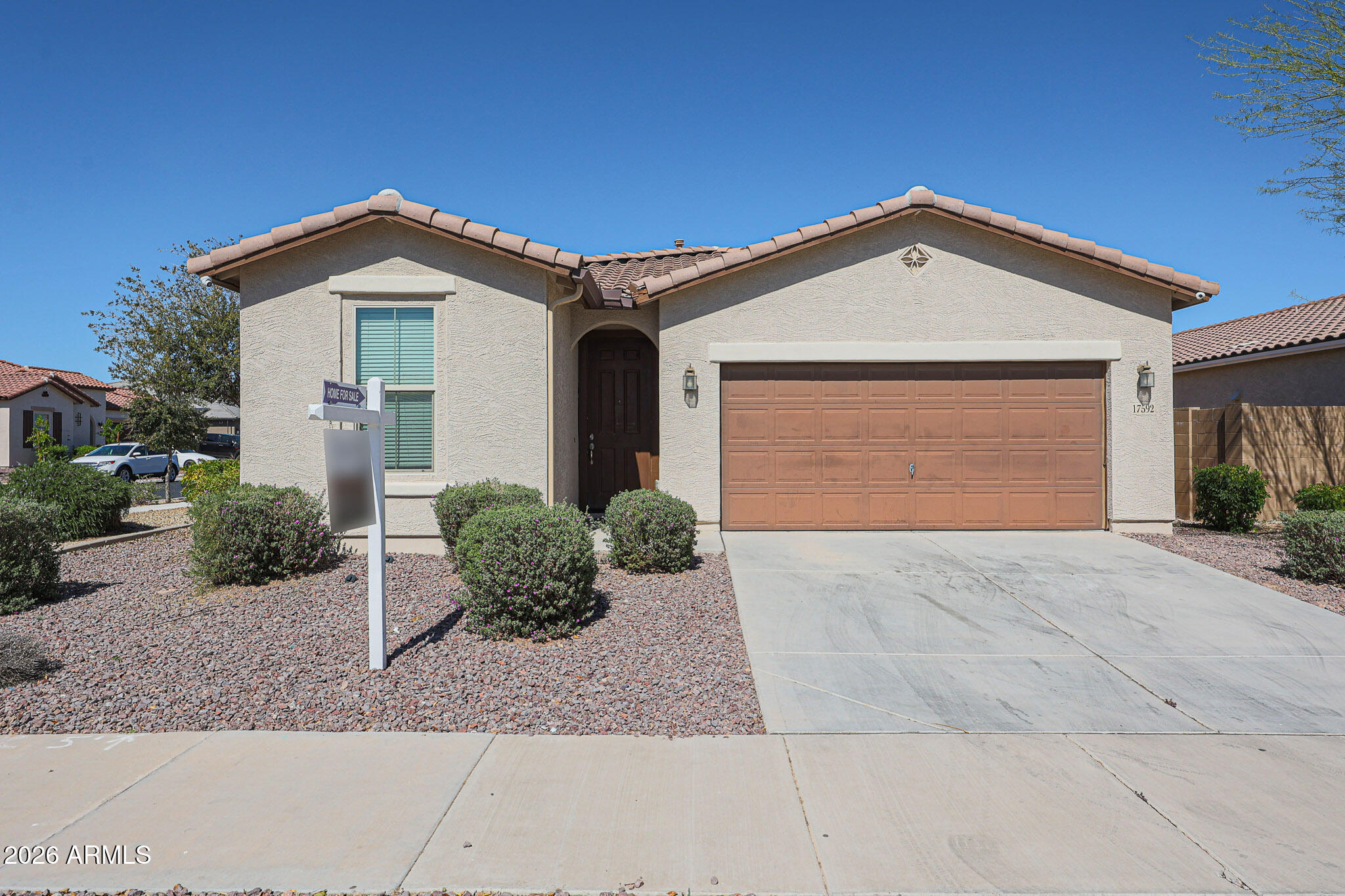17592 West Hadley Street Goodyear, AZ 85338 - Photo 1 of 20 a front view of a house with garden