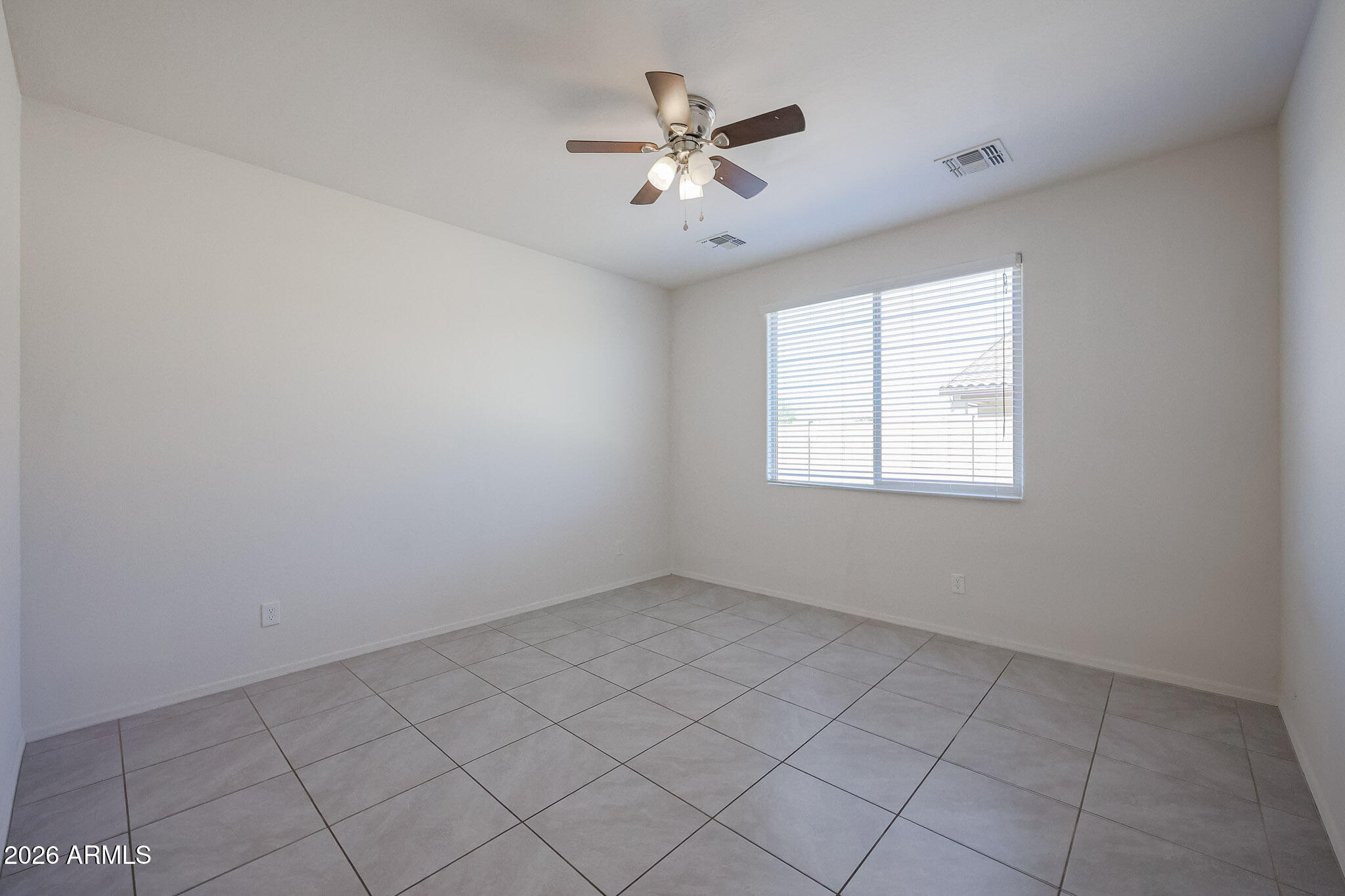 17592 West Hadley Street Goodyear, AZ 85338 - Photo 15 of 20 an empty room with windows and ceiling fan