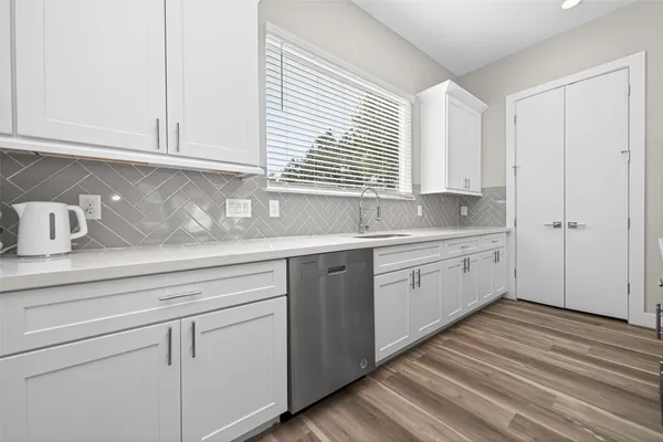 a kitchen with sink cabinets and window