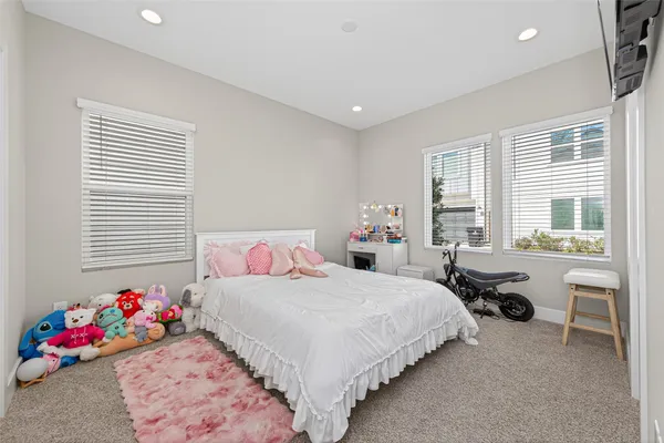 a bedroom with a bed and windows