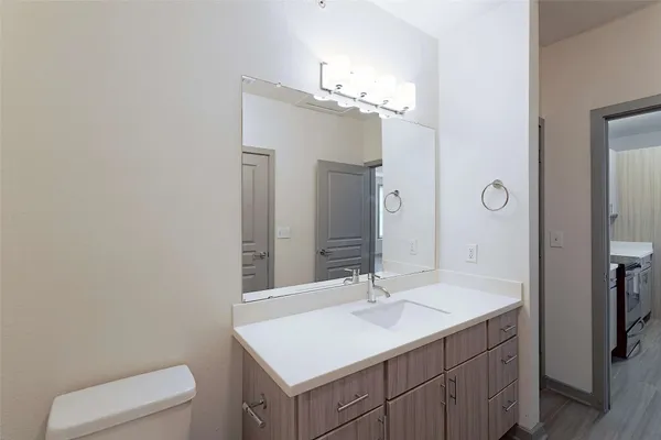 a view of a kitchen counter top space with sink wooden floor and windows