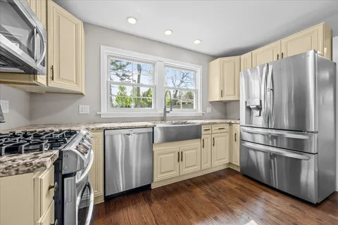 a kitchen with stainless steel appliances a stove a sink and a refrigerator