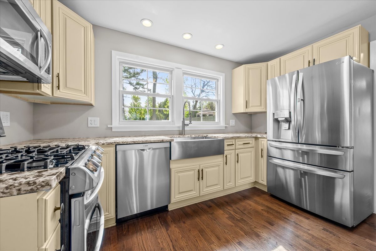 1541 Wilmot Road Deerfield, IL 60015 - Photo 11 of 25 a kitchen with stainless steel appliances a stove a sink and a refrigerator