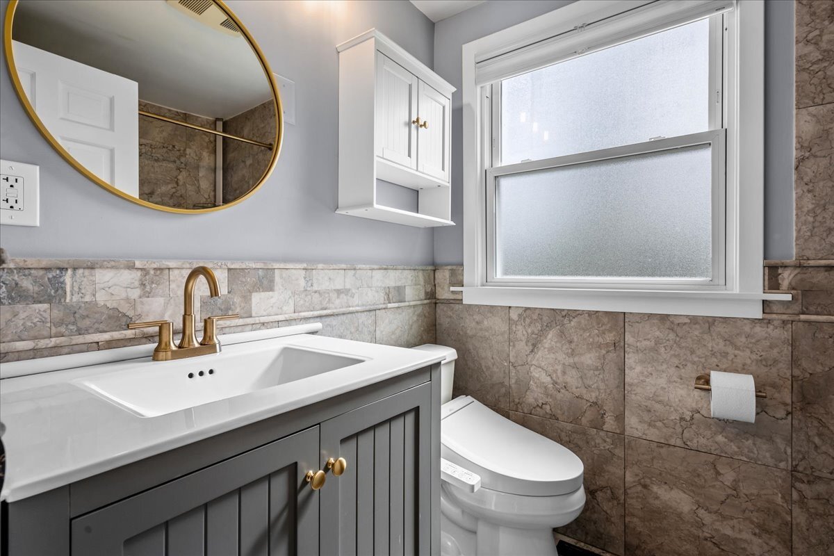 1541 Wilmot Road Deerfield, IL 60015 - Photo 14 of 25 a bathroom with a sink mirror and toilet