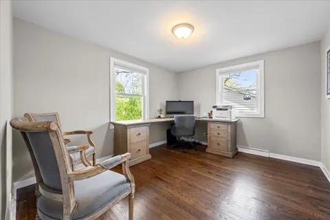 a workspace with furniture window and wooden floor