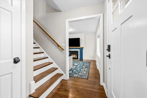 a view of entryway and hall with wooden floor