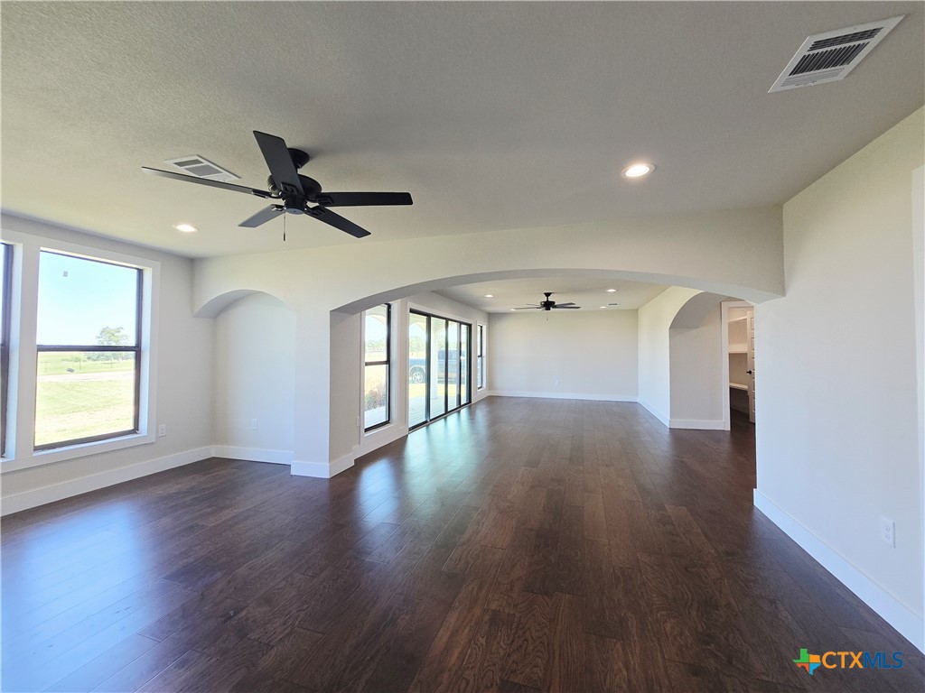 930 Elm Creek Road Rockdale, TX 76567 - Photo 11 of 25 wooden floor in an empty room with a window