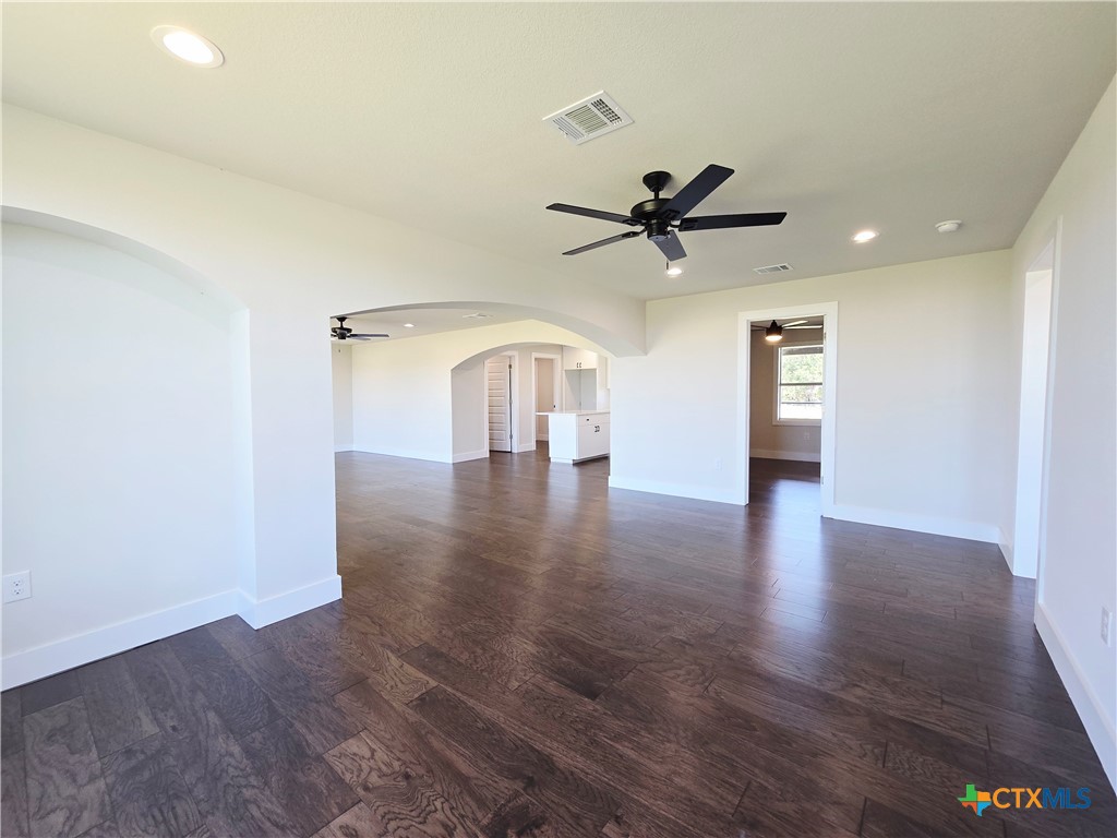 930 Elm Creek Road Rockdale, TX 76567 - Photo 12 of 25 a view of a livingroom with a ceiling fan and wooden floor