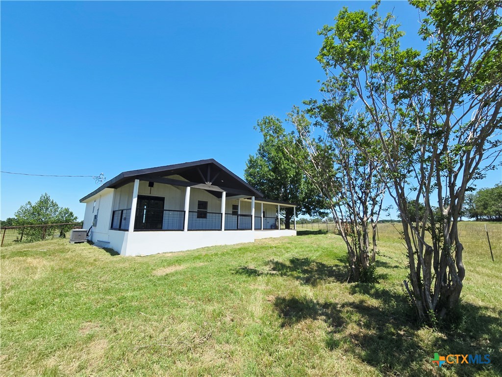 930 Elm Creek Road Rockdale, TX 76567 - Photo 19 of 25 a view of a house with a yard