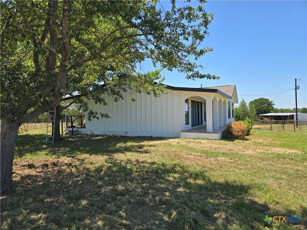 930 Elm Creek Road Rockdale, TX 76567 - Photo 5 of 25 a backyard of a house with a large tree